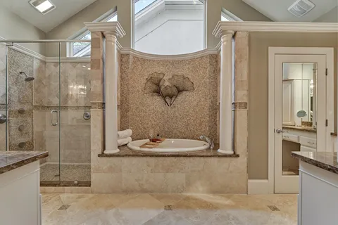 a spacious bedroom with a bed a chandelier and large window