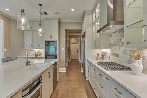 a kitchen with kitchen island a sink stove and refrigerator