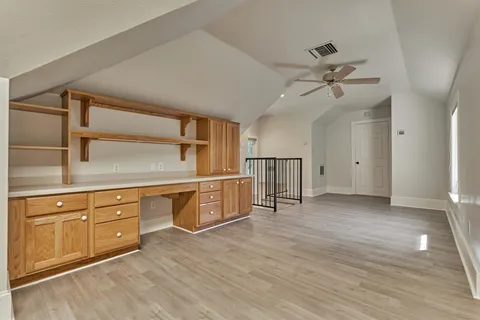 a view of a kitchen with a sink and cabinet with wooden floor