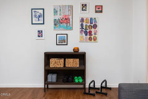 a living room with furniture and a wall painting