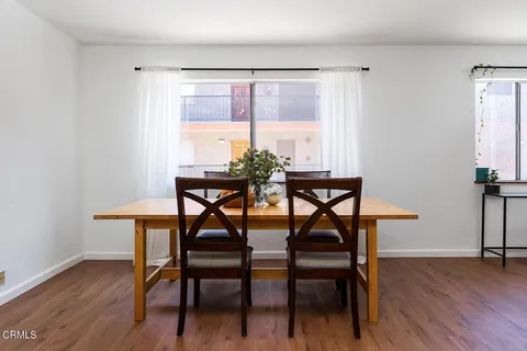 a dining room with furniture and wooden floor