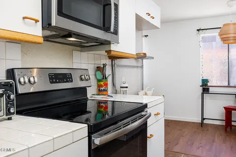 a kitchen with a stove and a refrigerator