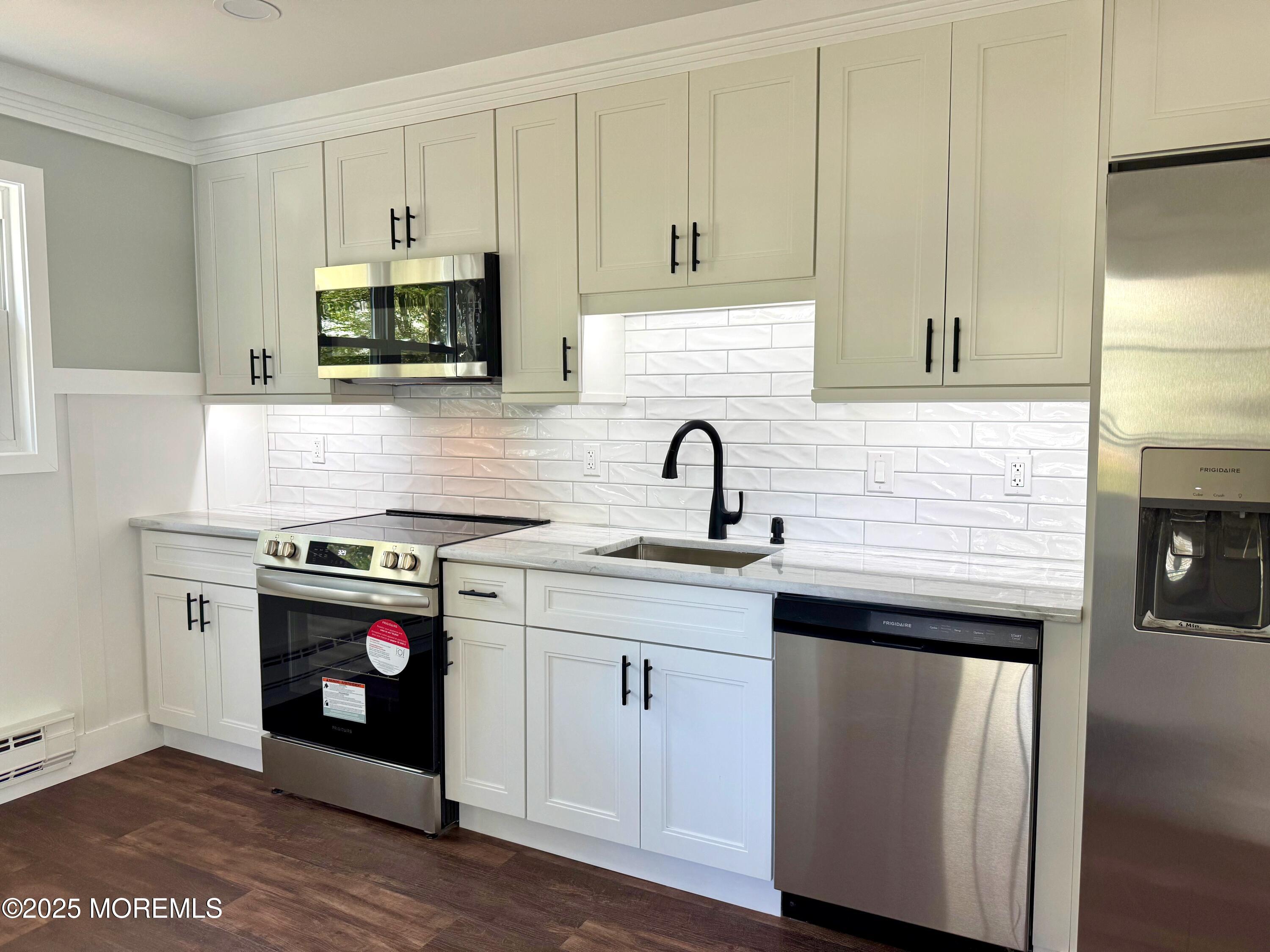 5 Nevada Drive Whiting, NJ 08759 - Photo 16 of 44 a kitchen with stainless steel appliances white cabinets a sink and a stove