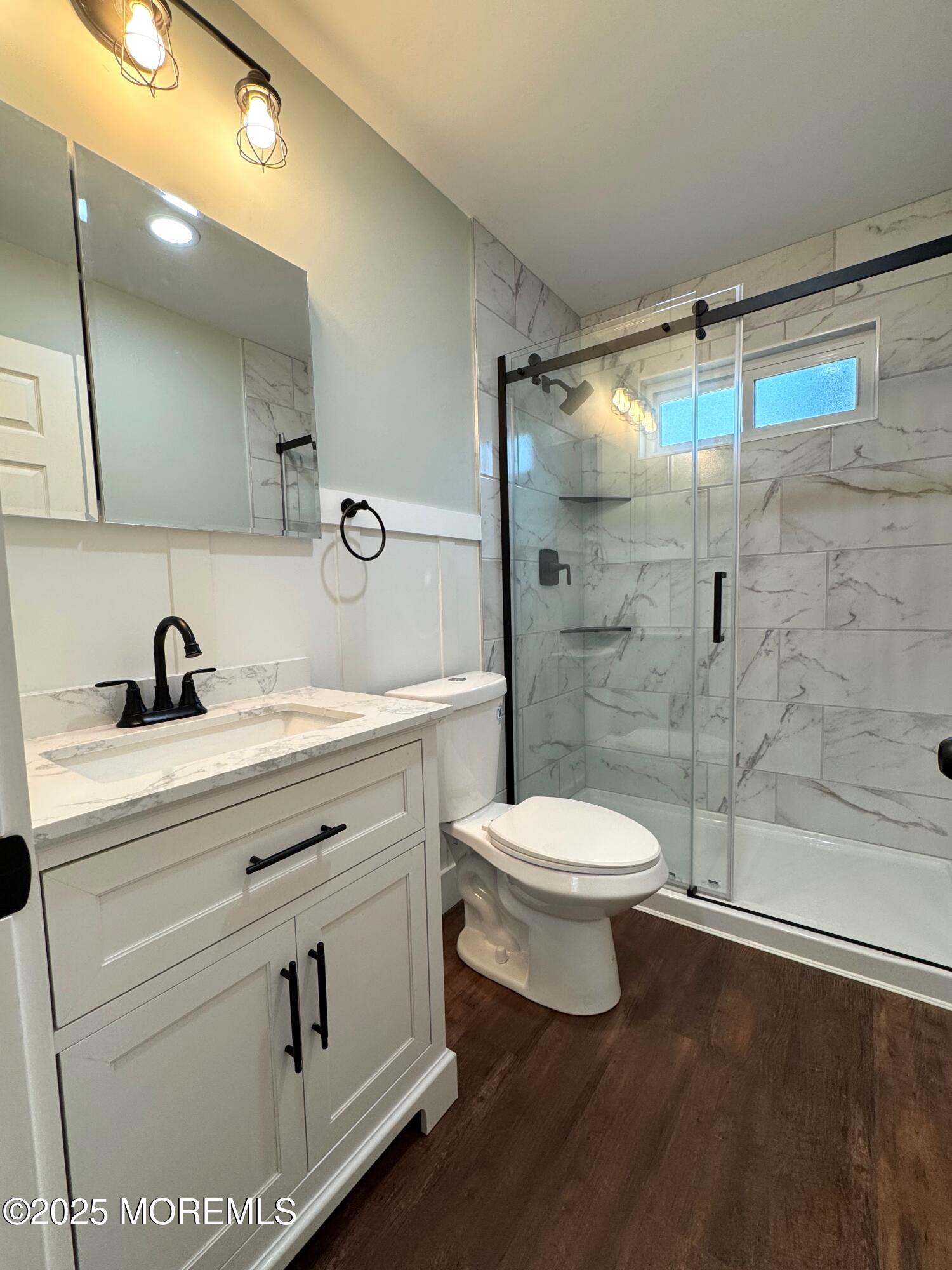 5 Nevada Drive Whiting, NJ 08759 - Photo 19 of 44 a bathroom with a toilet a sink and shower