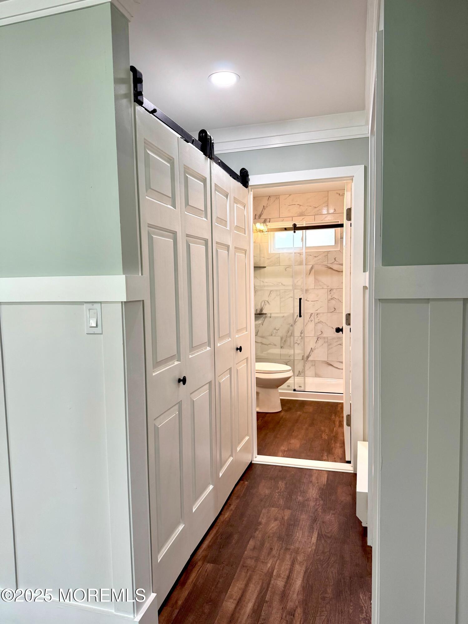 5 Nevada Drive Whiting, NJ 08759 - Photo 29 of 44 a view of a hallway with wooden floor and a bathroom