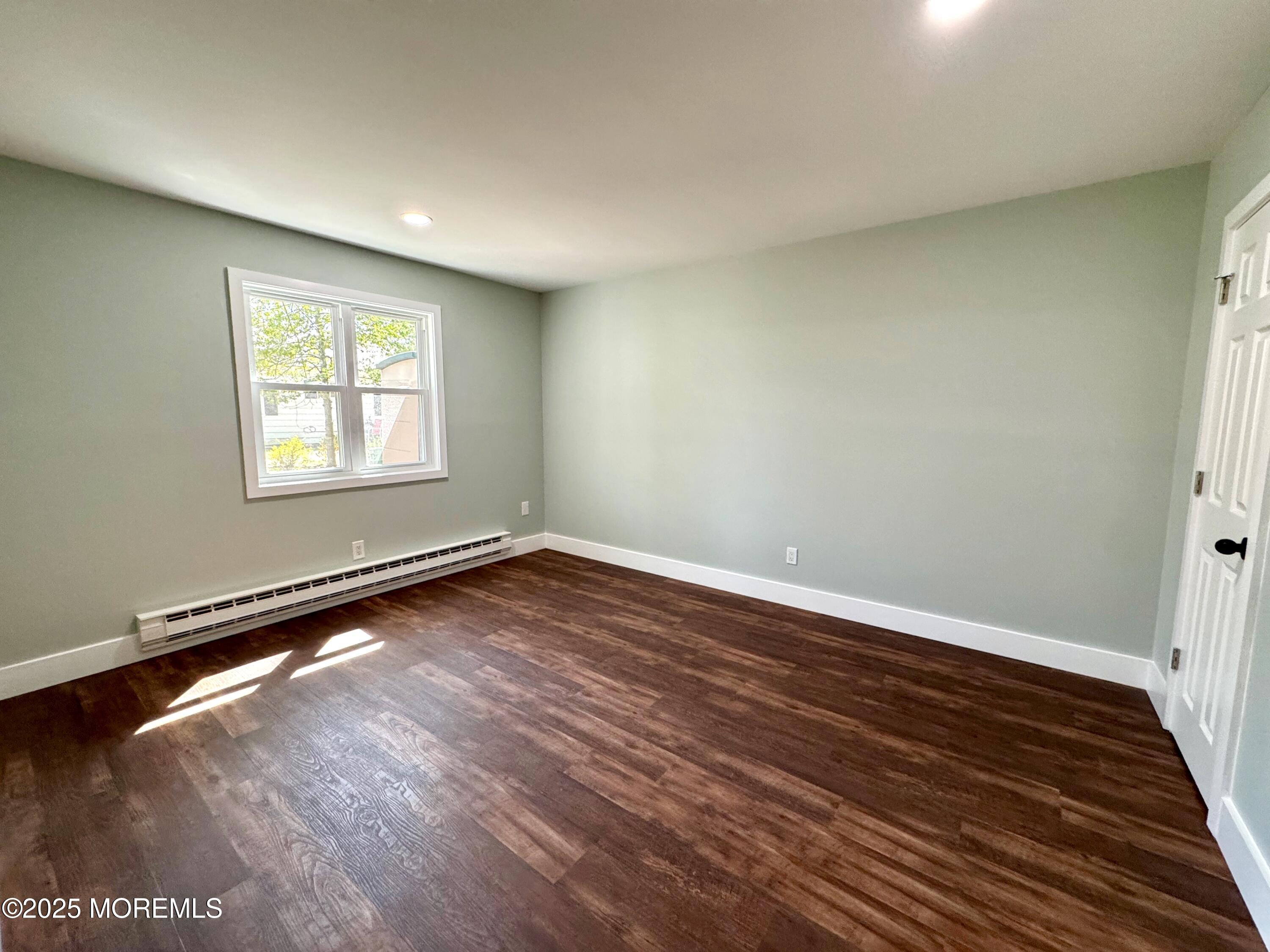 5 Nevada Drive Whiting, NJ 08759 - Photo 35 of 44 wooden floor in an empty room with a window
