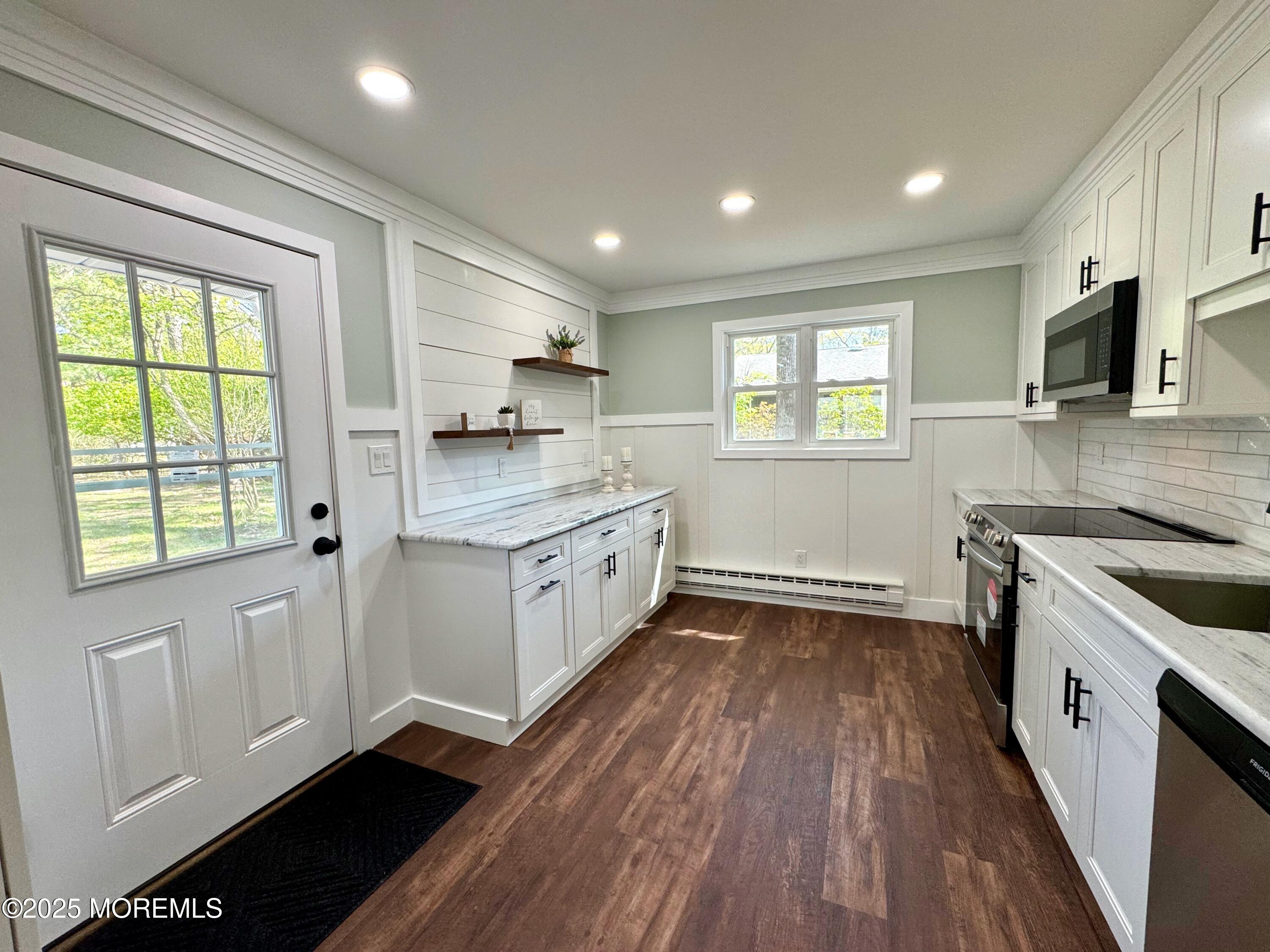 5 Nevada Drive Whiting, NJ 08759 - Photo 7 of 44 a kitchen with a sink wooden floor and a stove