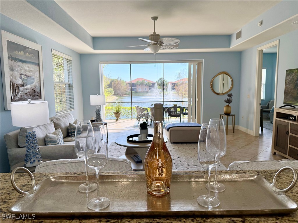 a view of a dining room with furniture a chandelier and large windows