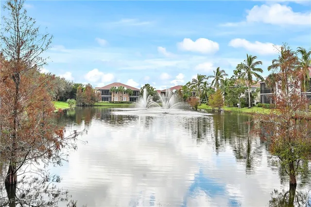a view of a lake with houses in the background