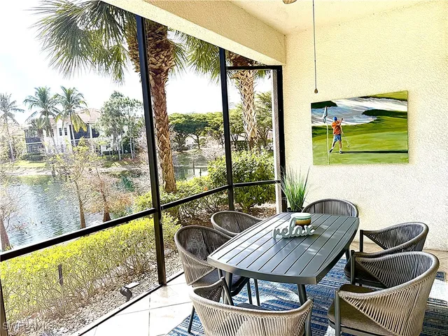 a dining room with furniture and a floor to ceiling window