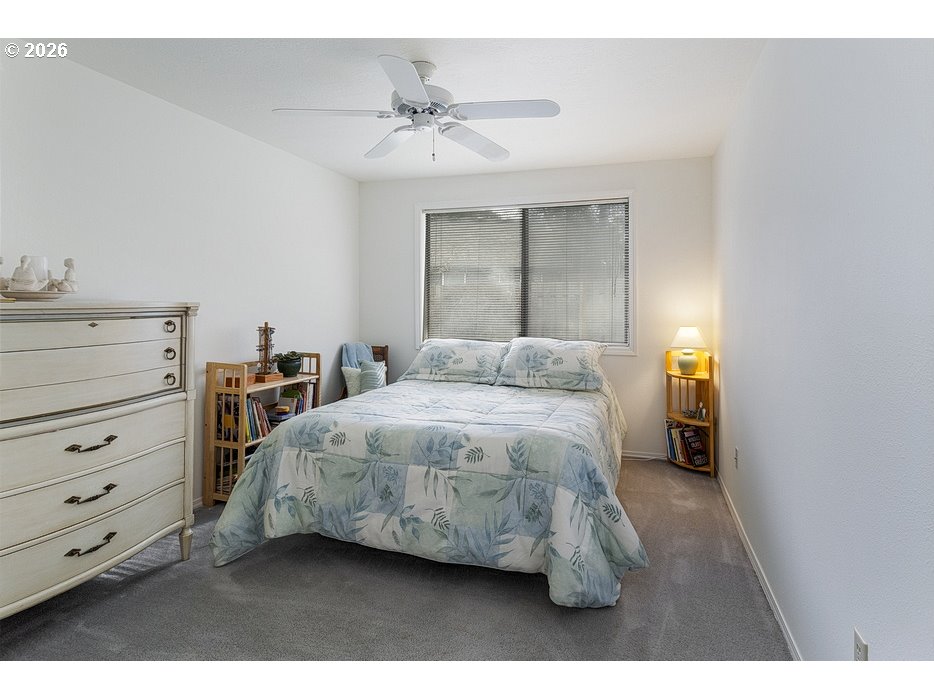 3788 Southeast 25th Street Gresham, OR 97080 - Photo 15 of 35 a bedroom with a bed and a chandelier