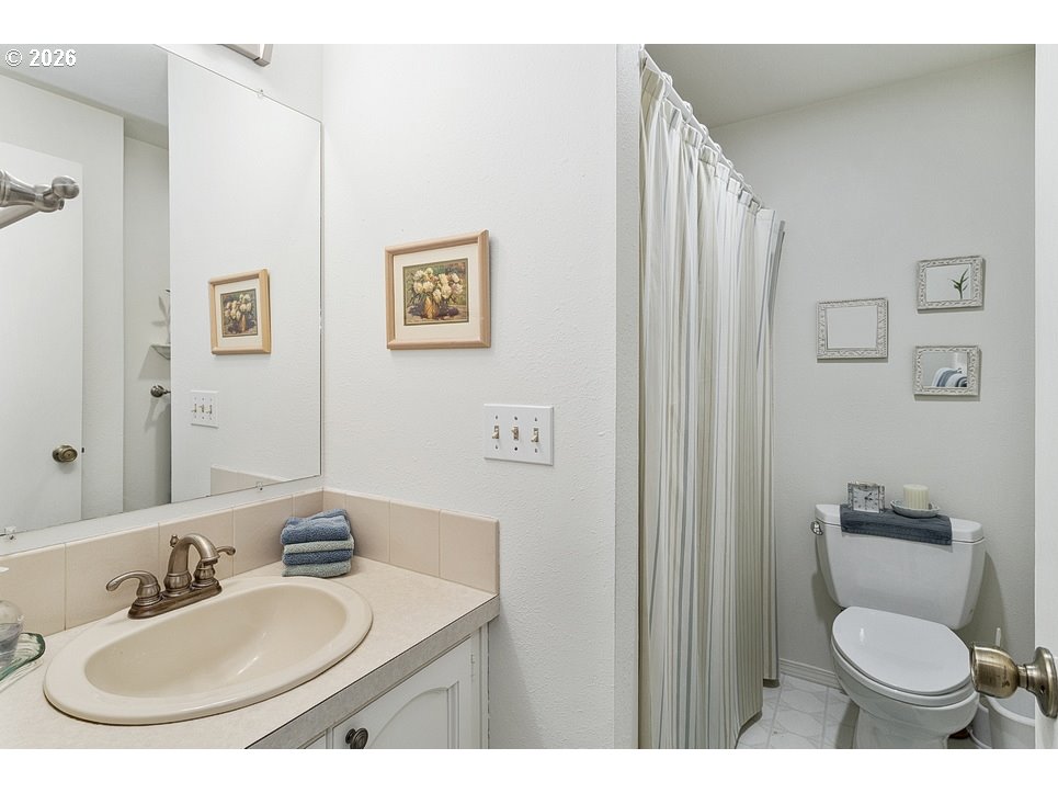 3788 Southeast 25th Street Gresham, OR 97080 - Photo 22 of 35 a bathroom with a toilet sink and mirror