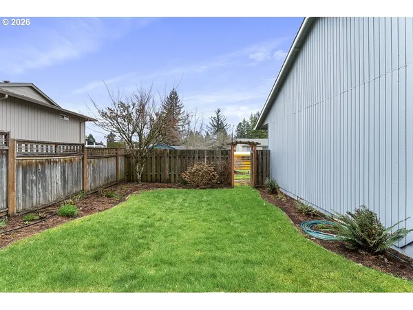 a backyard of a house with table and chairs