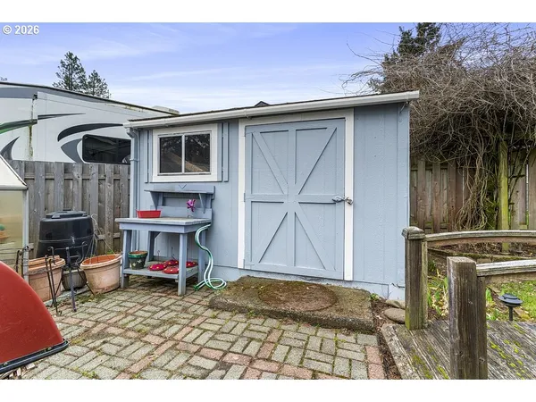 a view of a backyard with wooden fence