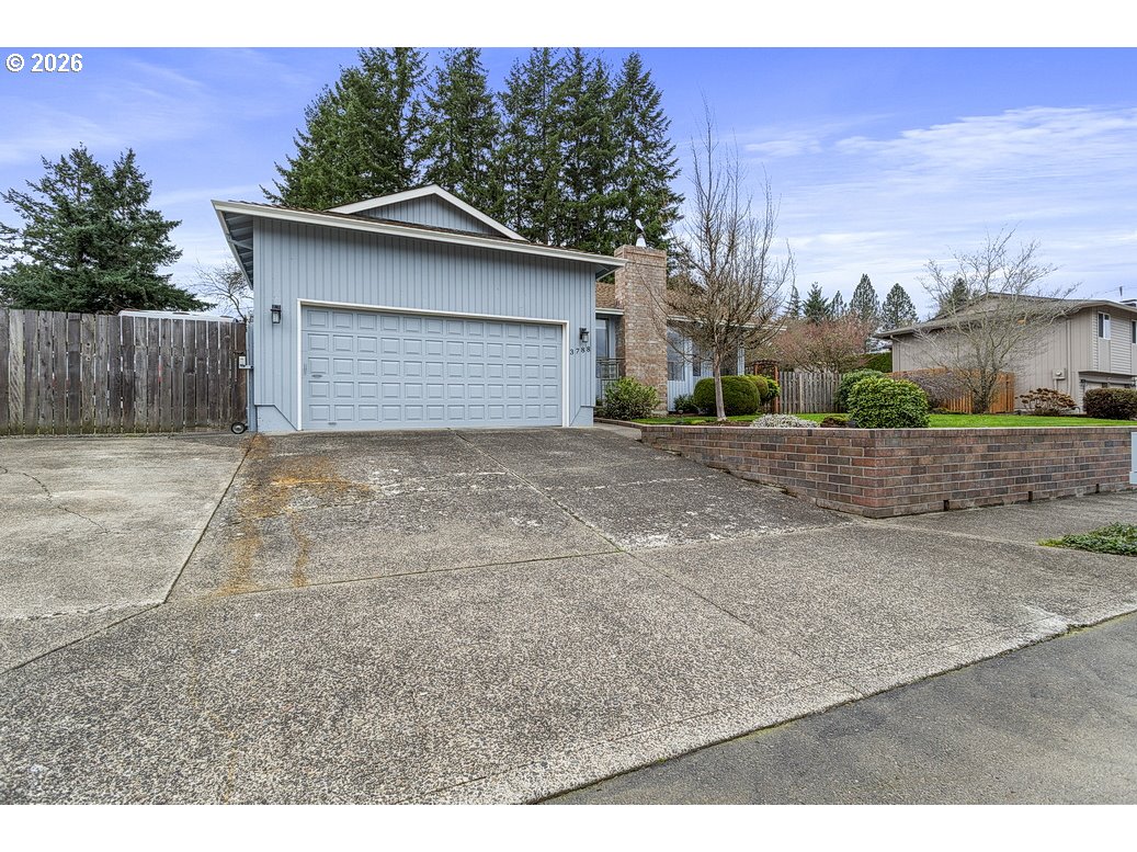 3788 Southeast 25th Street Gresham, OR 97080 - Photo 31 of 35 a front view of a house with a yard and garage