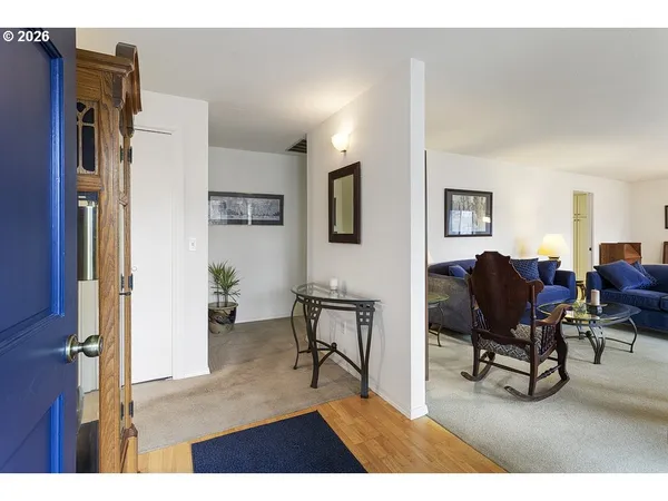 a living room with furniture rug and a window