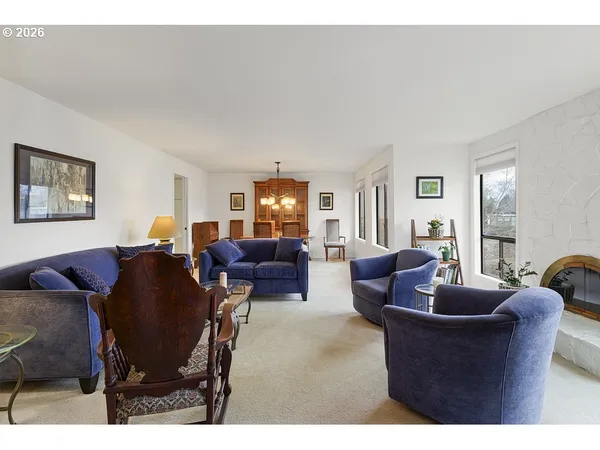 a living room with furniture a couch and two windows
