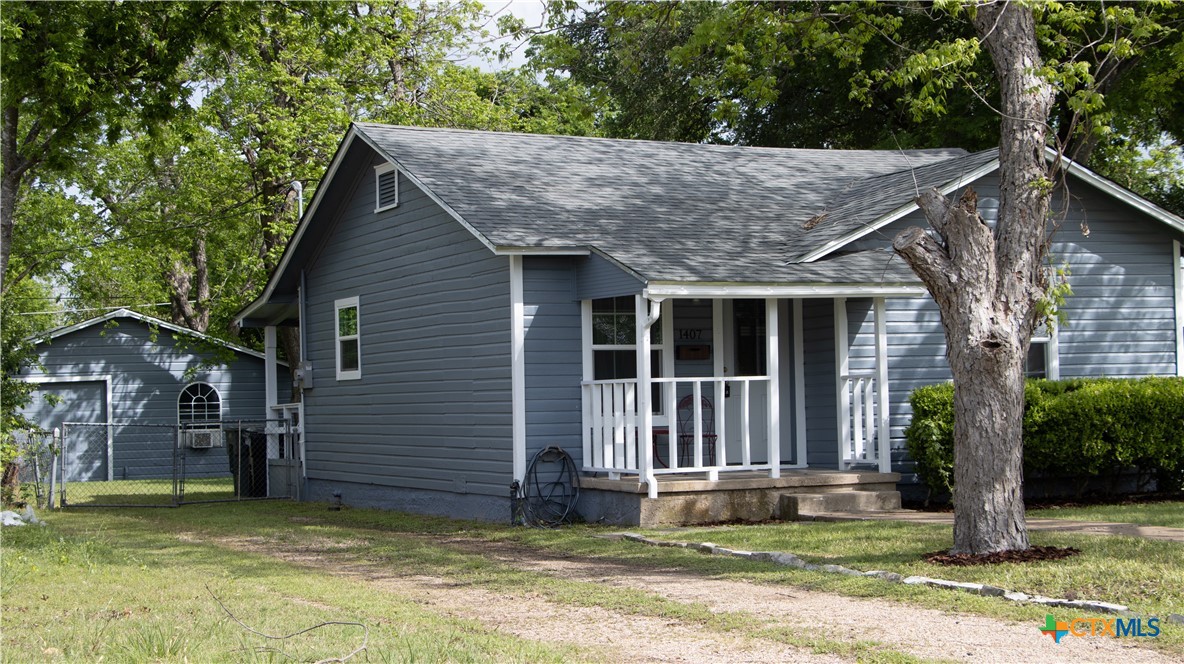 1407 South 7th Street Temple, TX 76504 - Photo 1 of 36 a view of a house with a yard plants and large tree