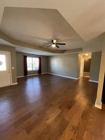 a view of an empty room and wooden floor