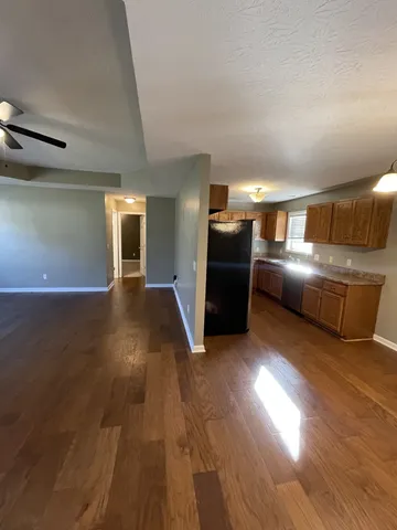 a kitchen with stainless steel appliances granite countertop a stove and a wooden floors