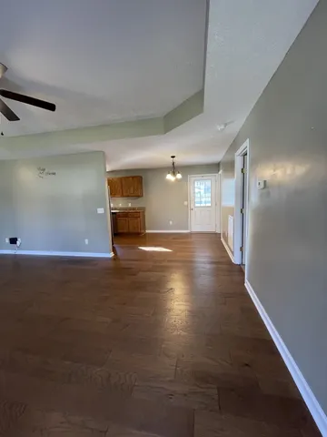 a kitchen with granite countertop a refrigerator and cabinets