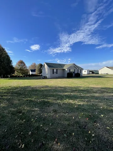 a view of an ocean with a floor to ceiling window and a yard