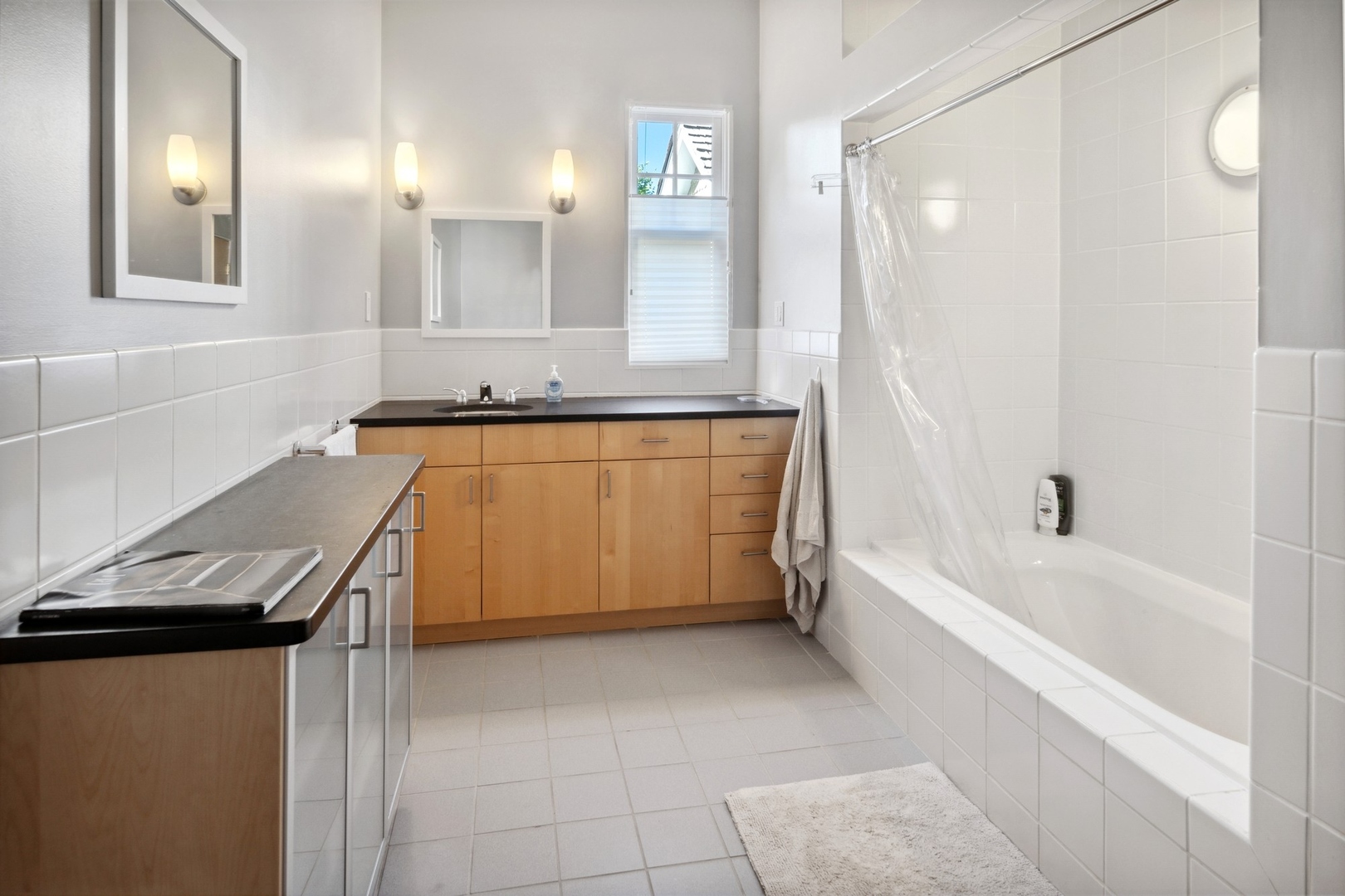 415 East Deerpath Road Lake Forest, IL 60045 - Photo 18 of 26 a bathroom with a granite countertop sink and a bathtub