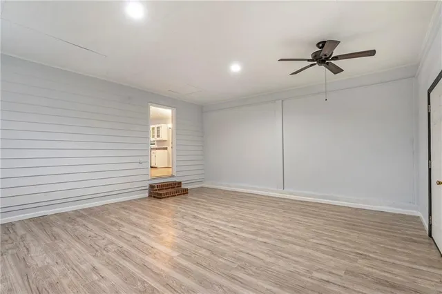 a view of an empty room and wooden floor