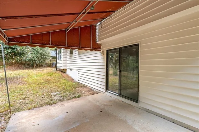 a backyard of a house with yard and outdoor seating