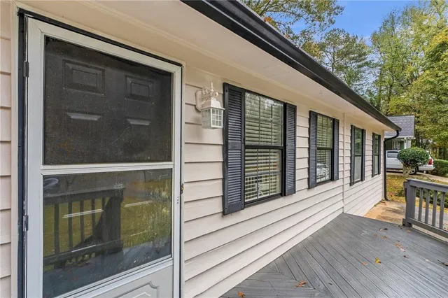 a view of a balcony with wooden floor and fence