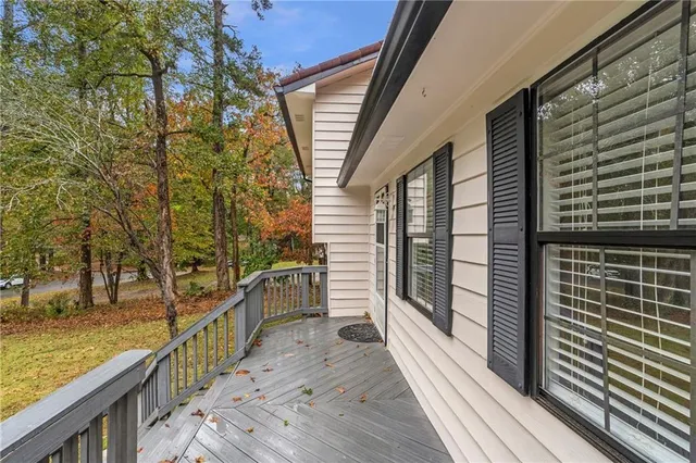 an empty room with wooden floor windows and outdoor view