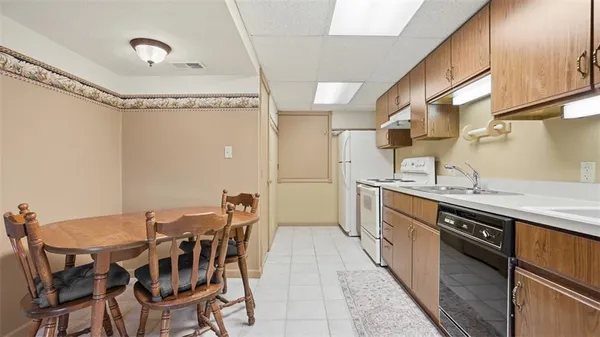 a kitchen with stainless steel appliances granite countertop a sink and a refrigerator