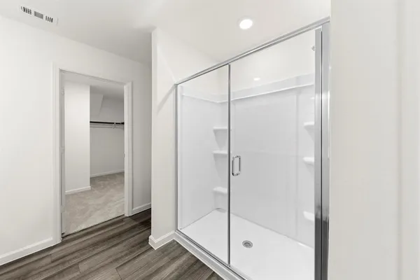 a bathroom with a glass shower door