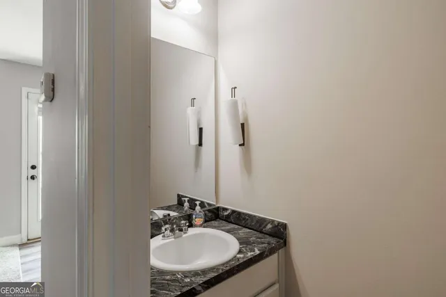 a living room with furniture a ceiling fan and a window