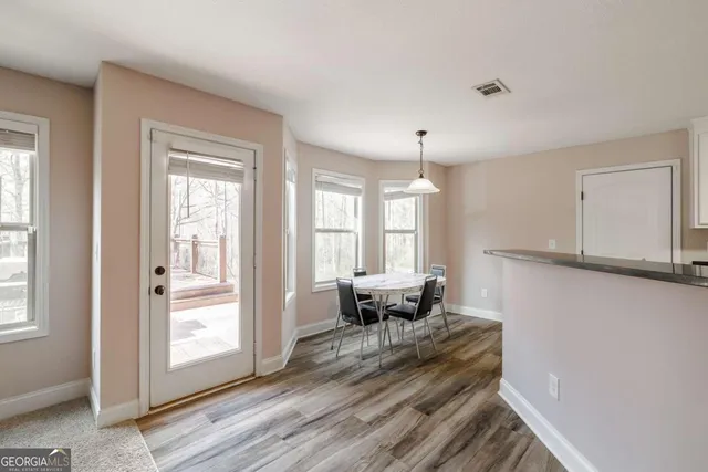 a kitchen with a refrigerator and a stove top oven