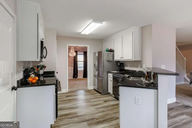 a kitchen with a sink stove top oven and microwave