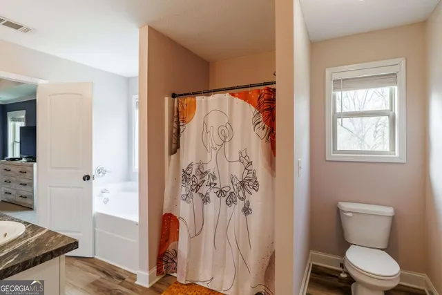 a bedroom with a bed and a television