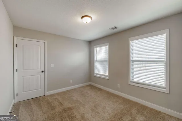 a view of dirt yard with a large trees