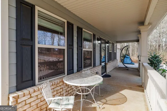 a view of an empty room with closet and a window