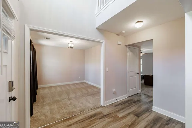 an empty room with windows and closet