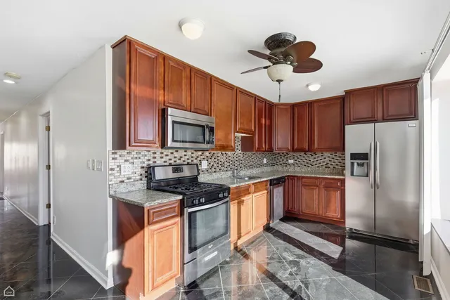 a kitchen with stainless steel appliances granite countertop a sink and cabinets