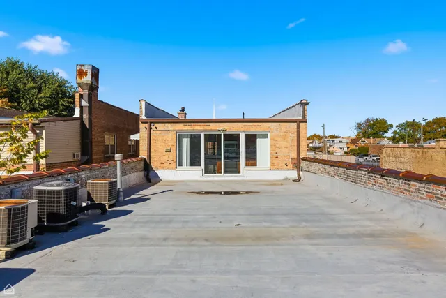 a large kitchen with stainless steel appliances granite countertop a stove refrigerator and cabinets