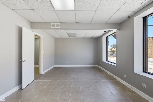 an empty room with windows and closet