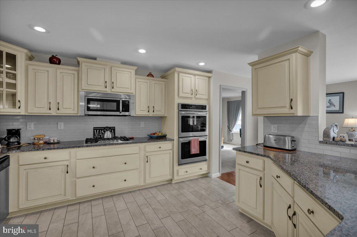 132 Strausser Road Hamburg, PA 19526 - Photo 11 of 67 a kitchen with stainless steel appliances granite countertop a stove a sink and white cabinets