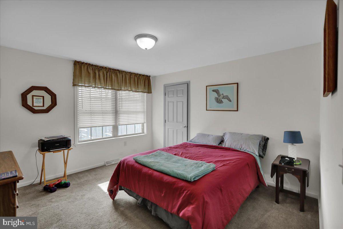 132 Strausser Road Hamburg, PA 19526 - Photo 20 of 67 a bedroom with a bed and a table in it with window