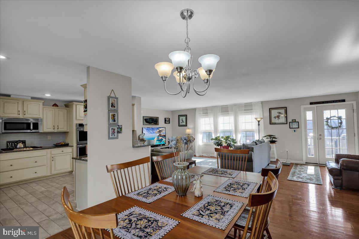 132 Strausser Road Hamburg, PA 19526 - Photo 7 of 67 a view of a dining room with furniture a chandelier and wooden floor