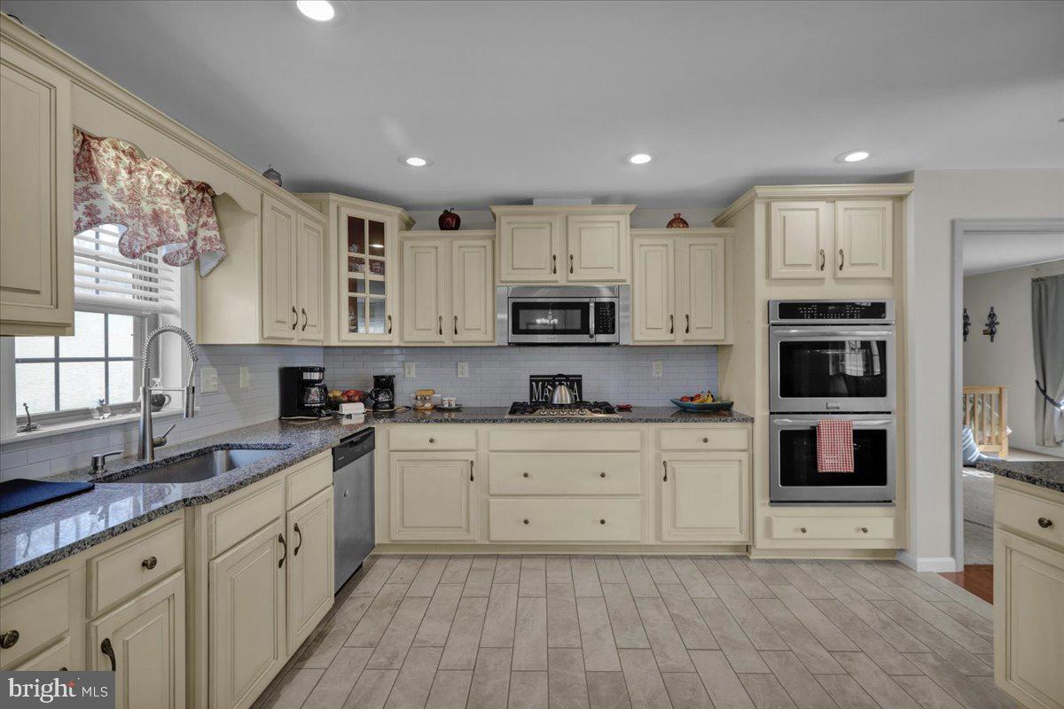 132 Strausser Road Hamburg, PA 19526 - Photo 8 of 67 a large kitchen with stainless steel appliances granite countertop a stove a sink and white cabinets