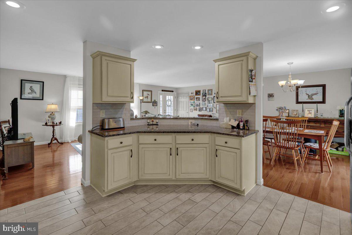 132 Strausser Road Hamburg, PA 19526 - Photo 10 of 67 a kitchen with stainless steel appliances granite countertop a stove a sink a dining table and chairs