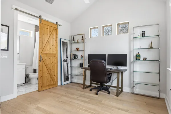 a view of a workspace with furniture and a bedroom