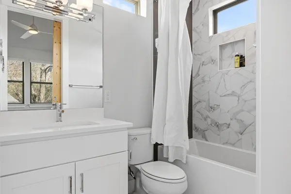 a bathroom with a sink toilet and shower